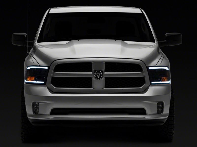 Raxiom 09-18 Dodge RAM 1500/2500/3500 Axial Series Headlights w/ LED Bar- Blk Housing (Clear Lens)