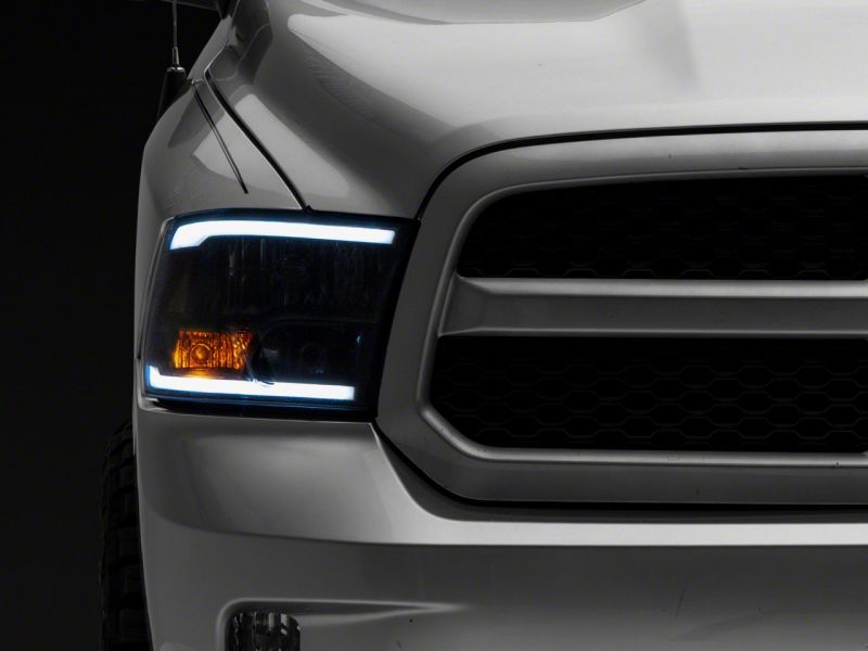 Raxiom 09-18 Dodge RAM 1500/2500/3500 Axial Series Headlights w/ LED Bar- Blk Housing (Clear Lens)